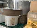 many pots and pans on the shelves in the kitchen