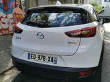 a white car parked on the side of the street