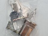 a bag of assorted keys on a white surface