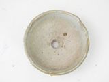 a white bowl with a hole in it on a table