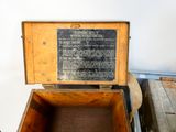 a wooden box with a sign on it sitting on a table