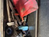 a red shovel in a metal box filled with assorted items