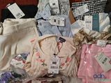 a lot of clothes that are sitting on a table