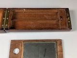 a small wooden box with a mirror on top of it