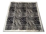 a black and white rug with a pattern on it