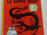 the cover of the book le lotus bleu is red with a dragon on it