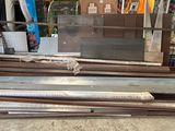 several pieces of metal are stacked on top of each other in a warehouse