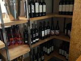 many bottles of wine on the shelves in this wine shop