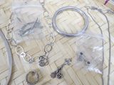 a lot of silver jewelry sitting on a table