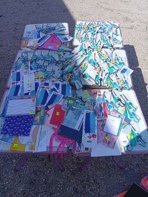 a table that has a lot of papers and scissors on it