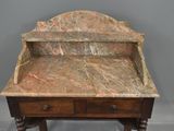 a marble top desk with a drawer underneath it