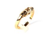 an image of a gold ring with black and white diamonds