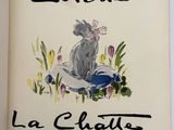 an open book with a drawing of a cat sitting on top of it