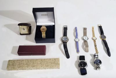 a lot of watches that are sitting on a table