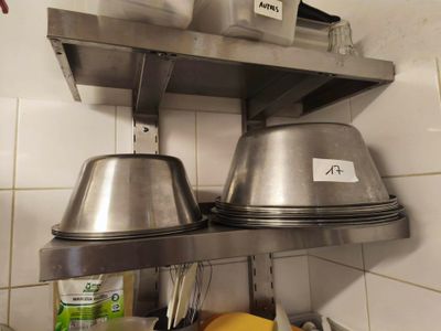 two pots and pans on the shelf in the kitchen