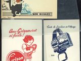 four different vintage french advertising posters on display in a store window
