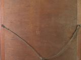 a picture of an old wooden box with a rope on it