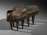 pair of bronze foot stools in the shape of a shoe