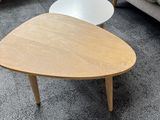 two coffee tables on a carpeted floor in a living room