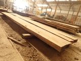 many pieces of wood sitting on the ground in a building