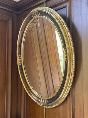 a mirror hanging on the wall in the corner of a room