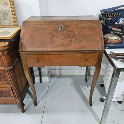 a small wooden desk with a drawer on top of it