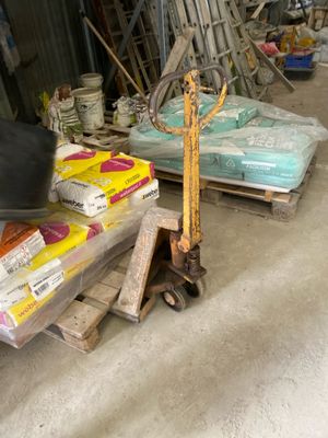 a man riding a scooter in a warehouse area