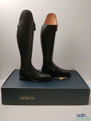 the black boots are sitting on top of a blue box