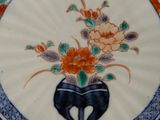 a plate with a vase of flowers on it