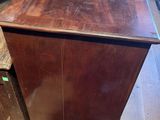 a wooden cabinet that is sitting in the middle of a room