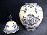 a blue and white vase next to a blue and white bowl