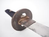 a close up of a knife on a white surface