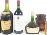 several bottles of liquor are lined up on a white surface