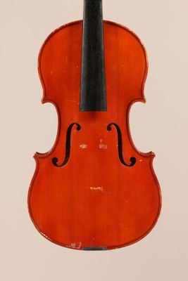 an old violin with a bow hanging from it ' s back