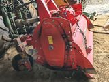 a red machine that is sitting in the dirt