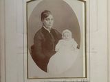 an old picture of a man holding a baby
