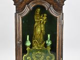 a small clock with a statue in the middle of it