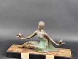 bronze statue of a woman sitting on a marble base