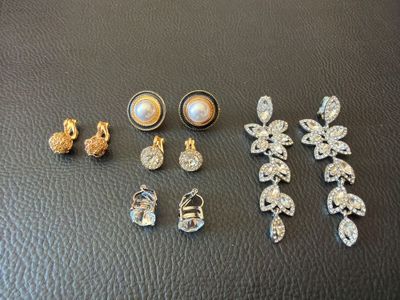a bunch of jewelry sitting on top of a black table