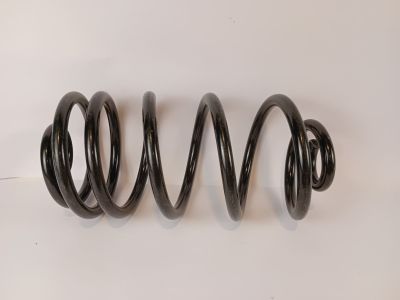 a close up of a black spring on a white surface