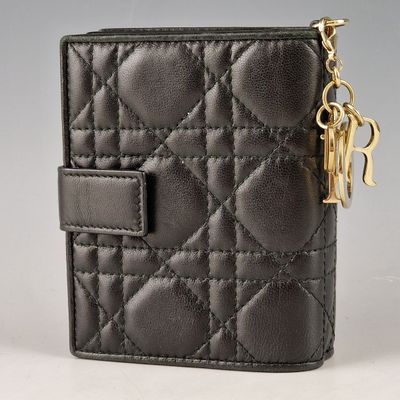 a black leather wallet with a gold chain hanging from the front