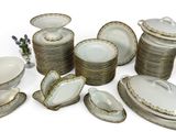 a lot of plates and bowls that are sitting on a table