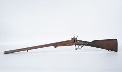 an old rifle with a wooden barrel and a wooden handle