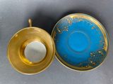a cup and saucer sitting next to each other on a table