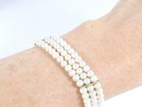 a close up of a person ' s arm wearing a bracelet