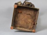 bronze figurine of a man on a horse in a box