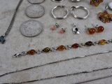 many different types of jewelry sitting on a table