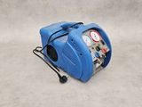 a blue air compressor sitting on top of a cement floor