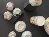 many different types of vases and bowls on the table