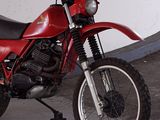 a red motorcycle that is parked in a garage